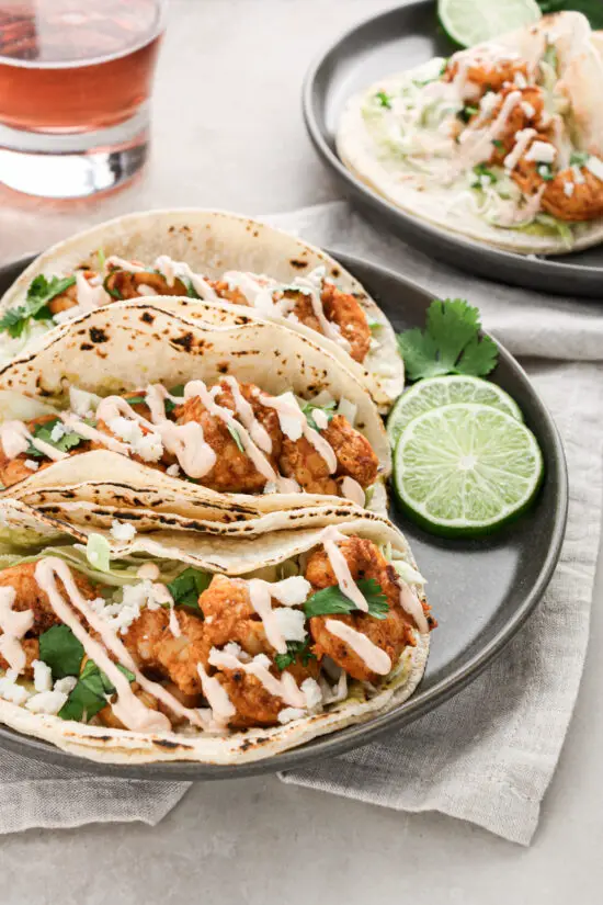 Spicy Shrimp Tacos with lime slices.