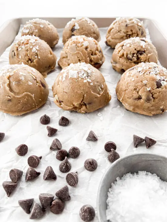 Chocolate chip pecan dough balls and scattered chocolate chips.