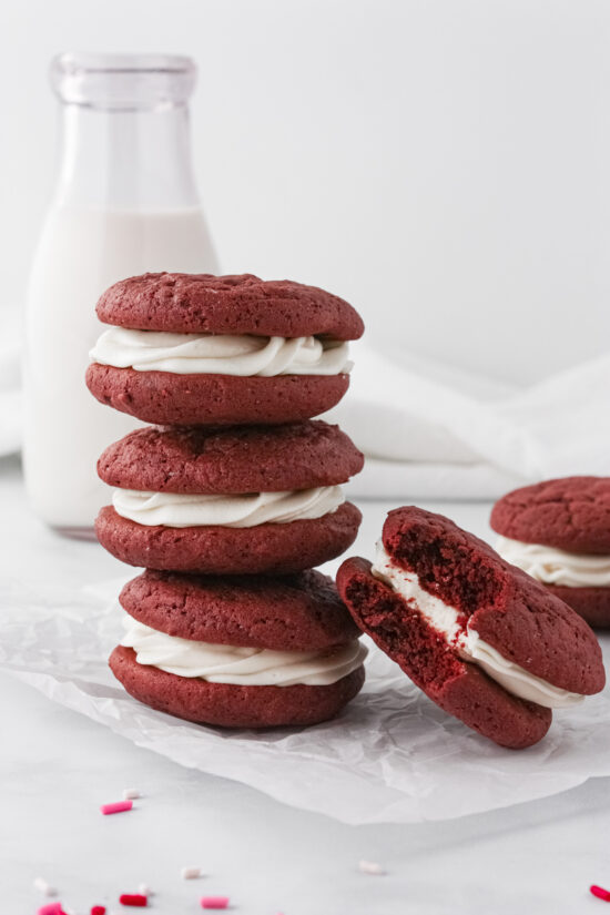Stacked red velvet whoopie pies with cream cheese filling.