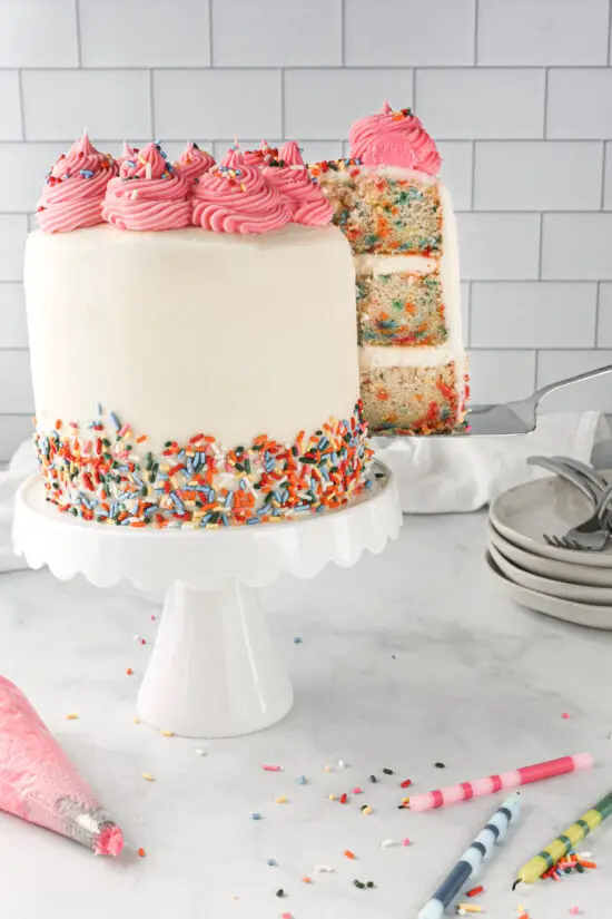 Gluten-Free Funfetti Cake with slice coming out of cake.