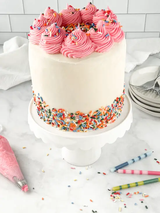 Gluten-Free Funfetti Cake with sprinkles on a cake plate.