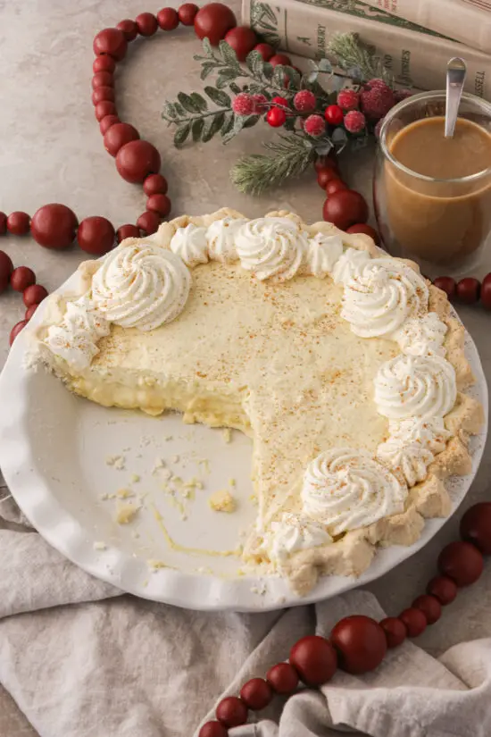 Pie pan filled with Eggnog Pie and whipped cream on top.
