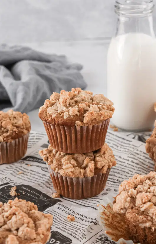 Applesauce Walnut Muffin stacked on top pf each other with small glass of milk.