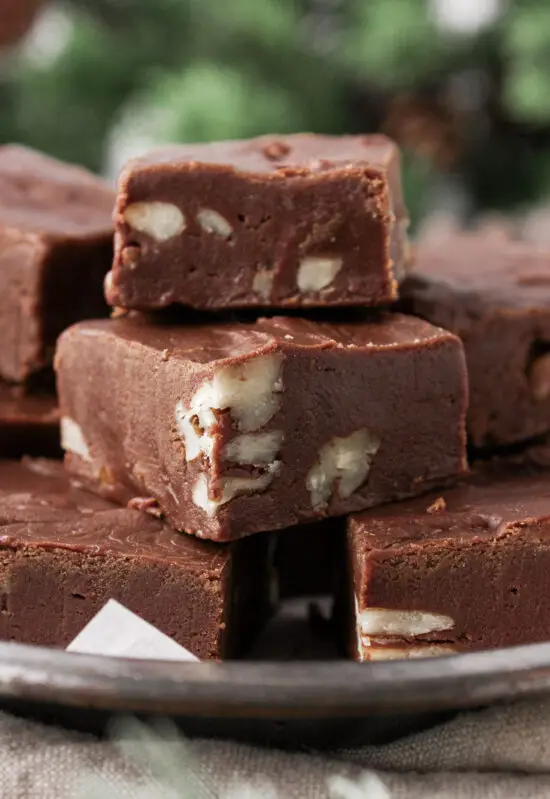 Stacked Easy Chocolate Pecan Fudge in a tin.