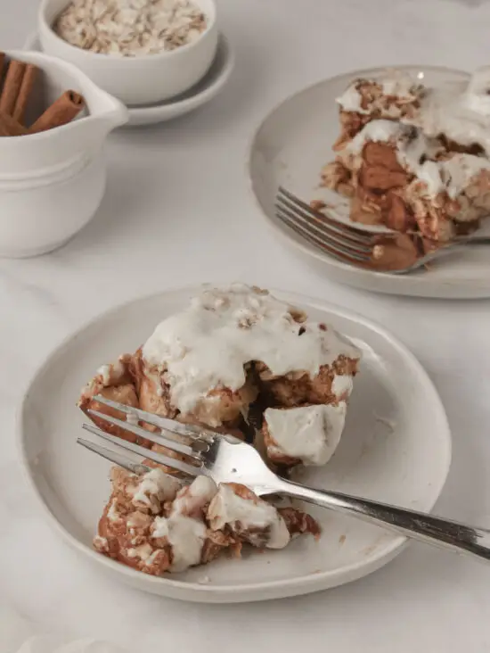Two desserts plates with slices of Apple Cinnamon Roll Casserole and forks. 
