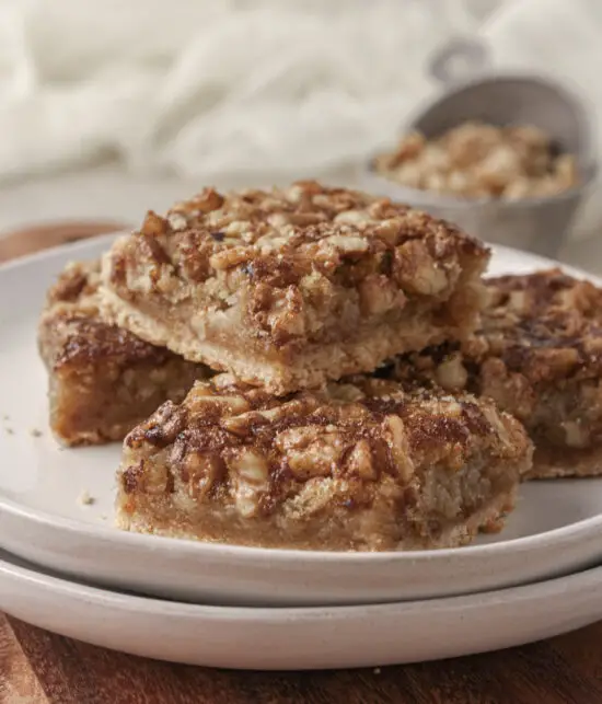 Four stacked Walnut Maple Bars on a plate. 