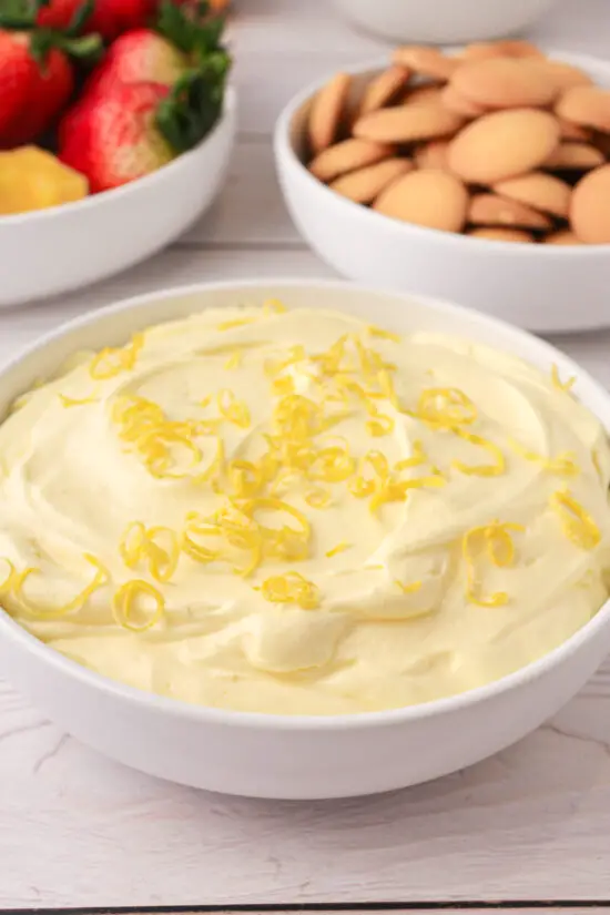 Bowl of Easy Lemon Fruit Dip with lemon zest on top.