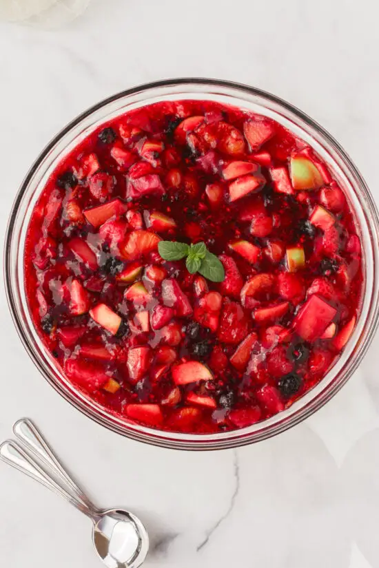 Large glass bowl filled with Easy Raspberry Jello Fruit Salad Recipe.