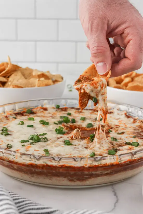 Corn chip dipped into Easy Chili Cheese Dip.